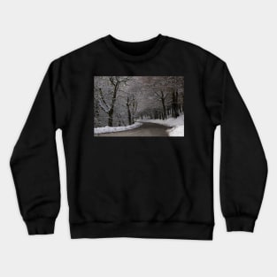 Snow covered woodland tree tunnel over road Crewneck Sweatshirt